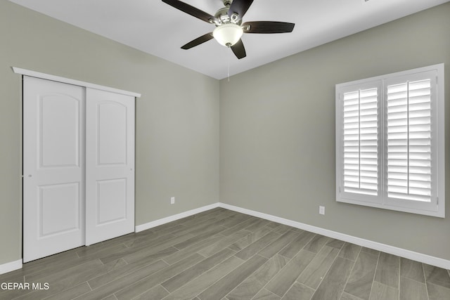 unfurnished bedroom featuring ceiling fan, light hardwood / wood-style floors, and a closet