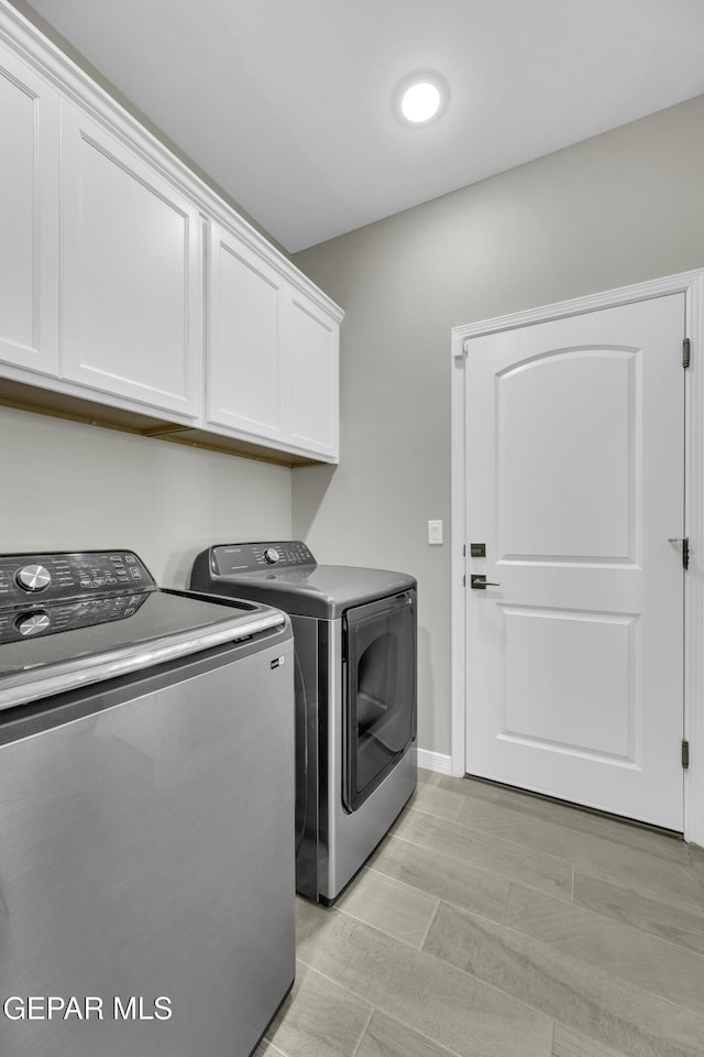 laundry area with cabinets and independent washer and dryer