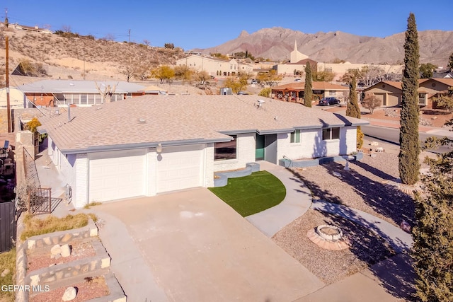 view of front of home with a mountain view and a garage