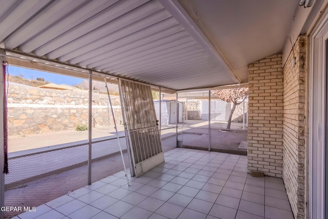 unfurnished sunroom with a wealth of natural light and vaulted ceiling