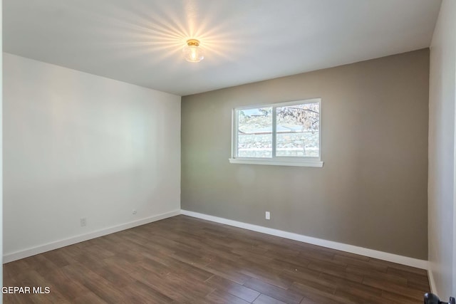 spare room featuring dark hardwood / wood-style flooring