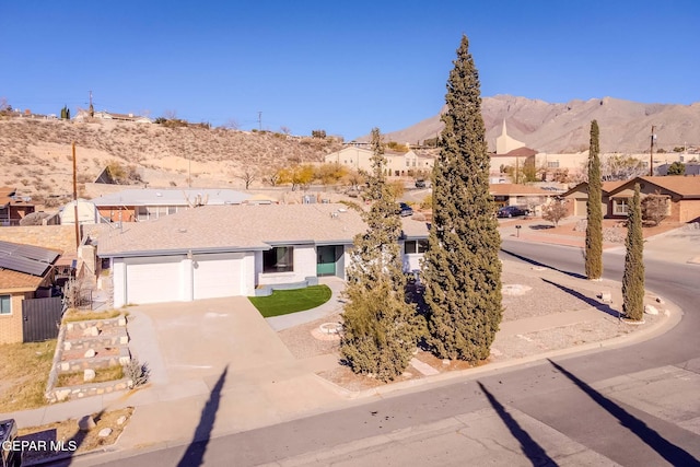 single story home with a mountain view and a garage