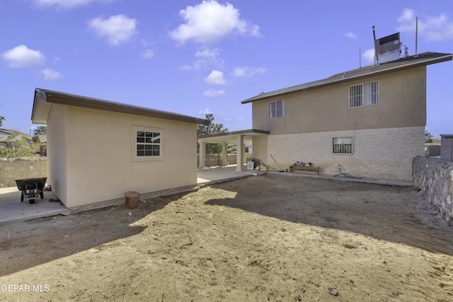 rear view of property featuring a patio area