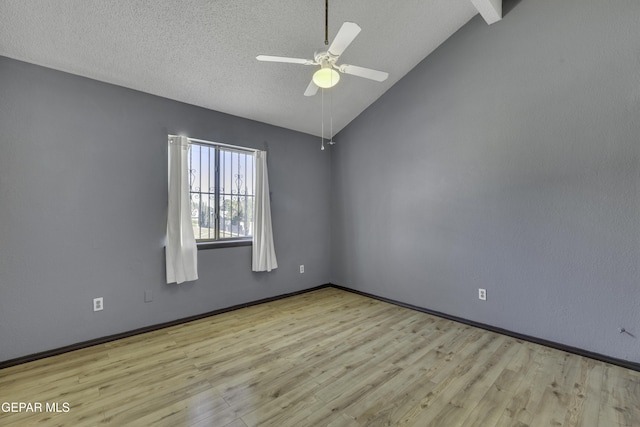 unfurnished room with vaulted ceiling with beams, ceiling fan, light wood-type flooring, and a textured ceiling