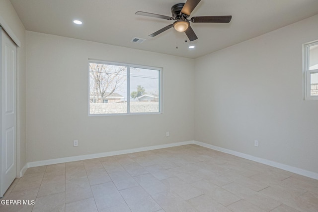 tiled empty room with ceiling fan