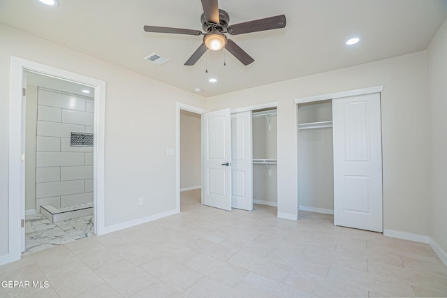 unfurnished bedroom featuring ceiling fan and multiple closets