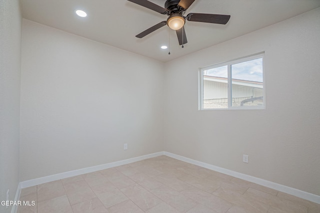 spare room with ceiling fan and light tile patterned flooring