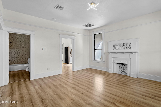 unfurnished living room with light hardwood / wood-style floors