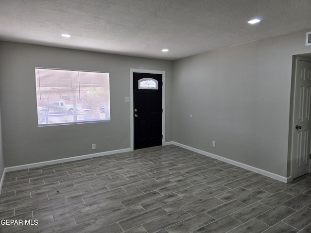 foyer featuring a textured ceiling