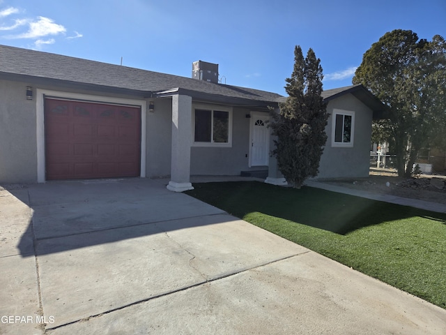 ranch-style home with central AC, a garage, and a front lawn