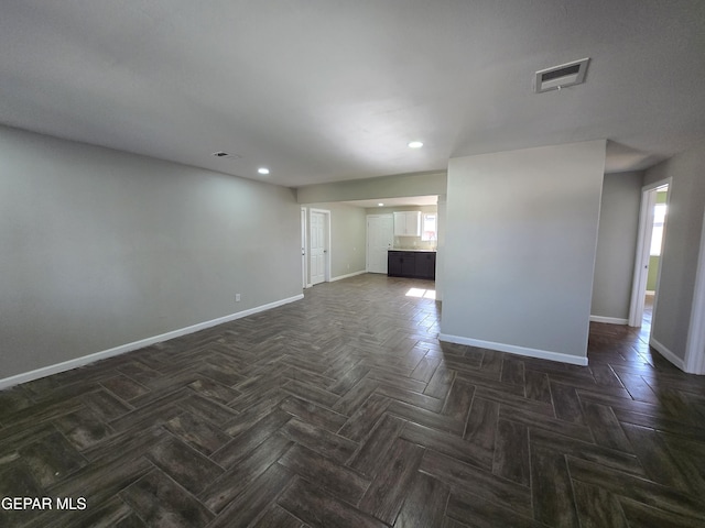 unfurnished living room with dark parquet floors