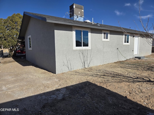 back of house with central AC