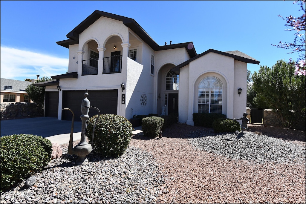 view of front of property with a balcony and a garage