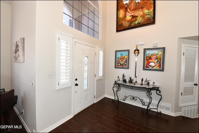 entryway featuring a towering ceiling