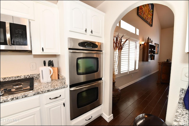 550 Shadow Willow Dr, El Paso, TX 79922 - kitchen with light stone countertops, white cabinetry, stainless steel appliances, and dark hardwood / wood-style floors