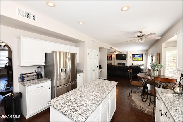 550 Shadow Willow Dr, El Paso, TX 79922 - kitchen with light stone countertops, stainless steel refrigerator with ice dispenser, ceiling fan, white cabinets, and a kitchen island