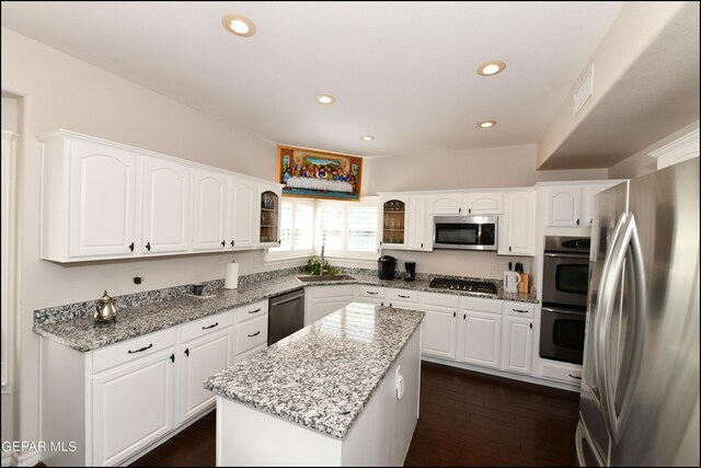 550 Shadow Willow Dr, El Paso, TX 79922 - kitchen with sink, appliances with stainless steel finishes, a kitchen island, light stone counters, and white cabinetry