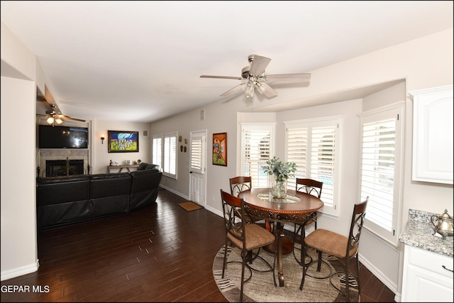 550 Shadow Willow Dr, El Paso, TX 79922 - dining space with a fireplace, ceiling fan, and dark wood-type flooring