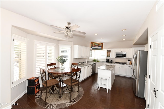 550 Shadow Willow Dr, El Paso, TX 79922 - kitchen with light stone counters, stainless steel appliances, sink, white cabinets, and a center island