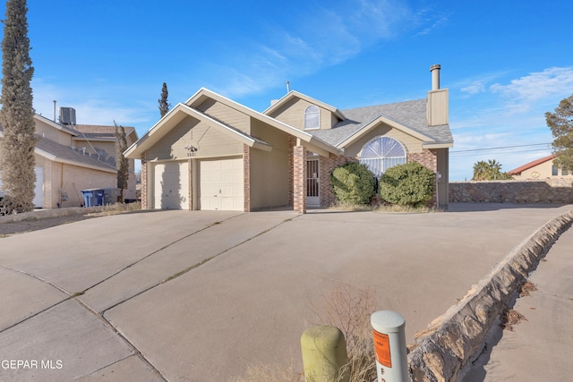 view of front of property with central AC unit and a garage