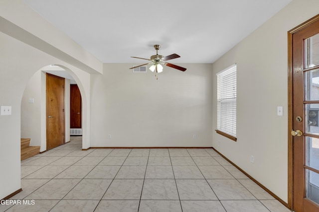 spare room with light tile patterned floors and ceiling fan