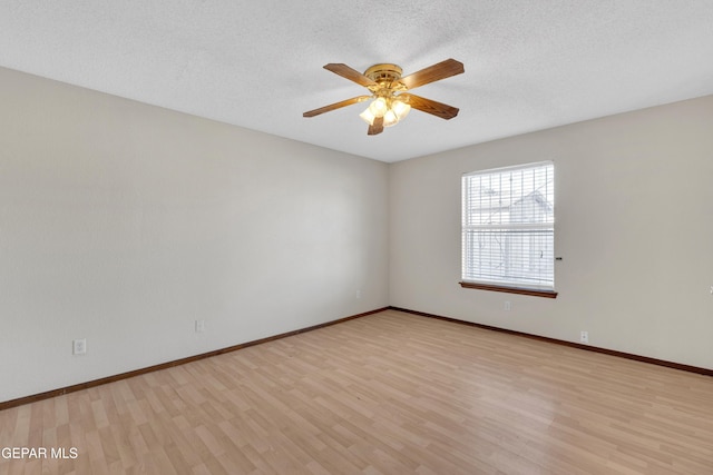 empty room featuring ceiling fan, a textured ceiling, and light wood-type flooring