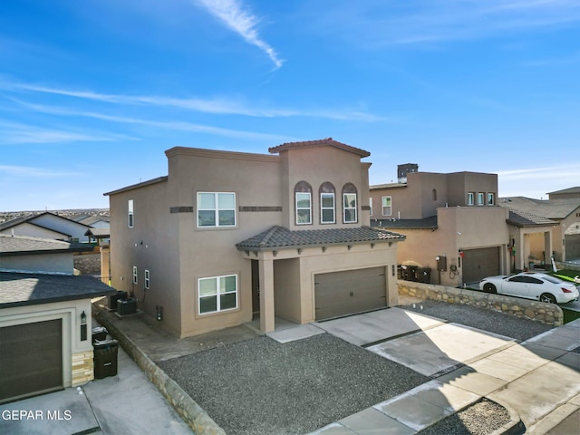 view of front of property featuring cooling unit and a garage