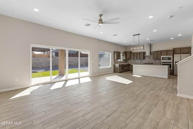 unfurnished living room with ceiling fan