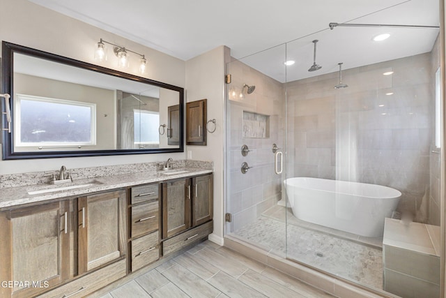 bathroom with vanity and independent shower and bath