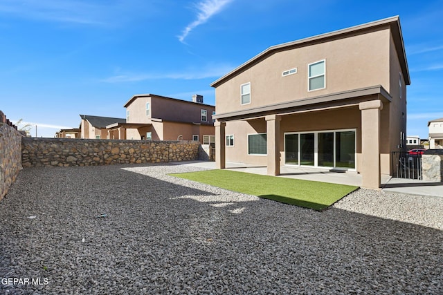 rear view of property featuring a patio area