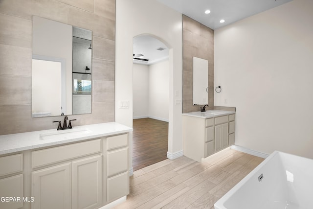 bathroom featuring a bathtub, wood-type flooring, and vanity