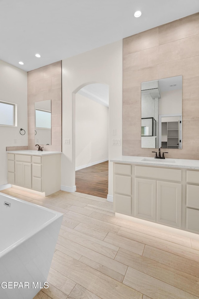 bathroom with a bathing tub and vanity