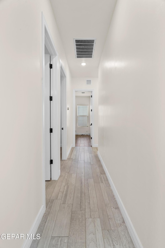 corridor with light wood-type flooring