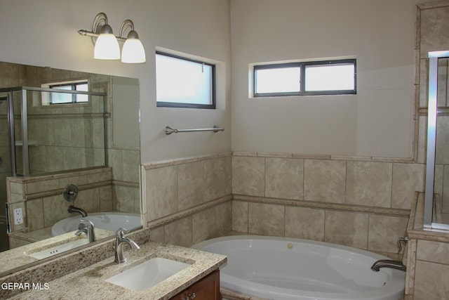 bathroom with vanity and a washtub