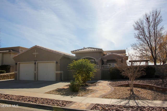 mediterranean / spanish home featuring a garage