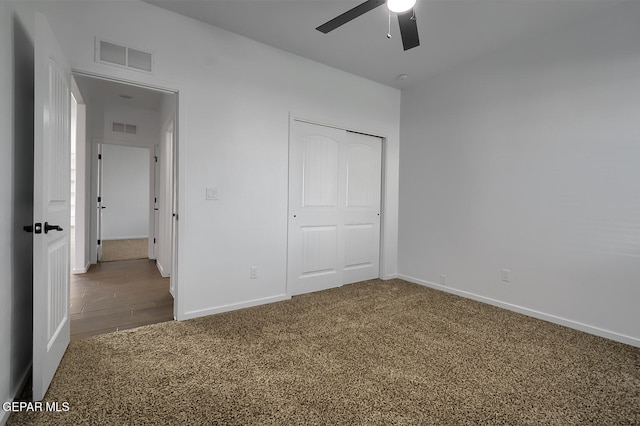 unfurnished bedroom with baseboards, visible vents, and carpet