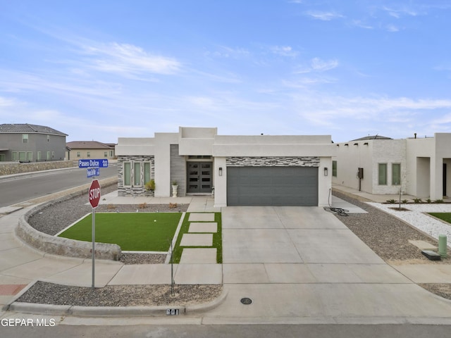 pueblo revival-style home featuring a garage