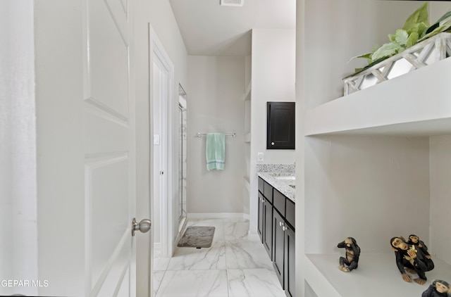 bathroom featuring vanity and an enclosed shower