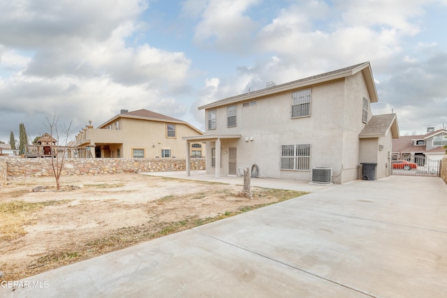 back of property with cooling unit and a patio area