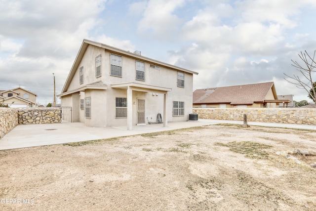 back of property with a patio area and central air condition unit