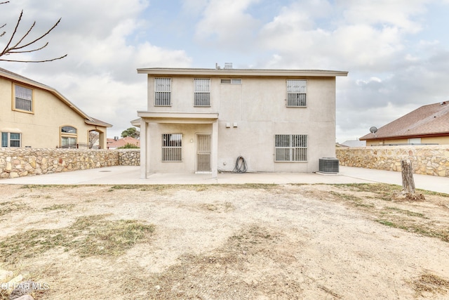 rear view of house featuring central AC and a patio