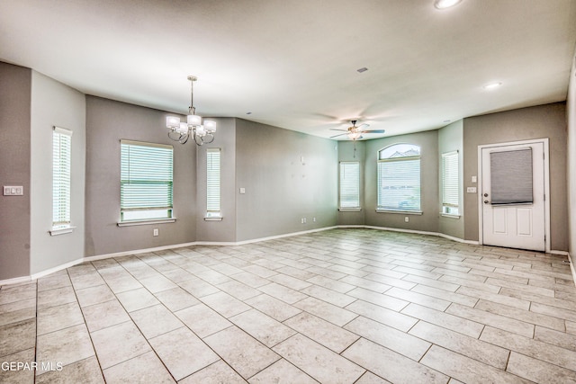 unfurnished room featuring ceiling fan with notable chandelier