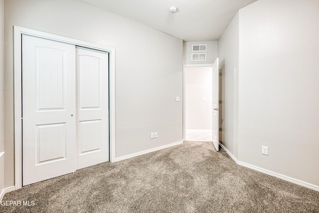 unfurnished bedroom featuring carpet floors and a closet