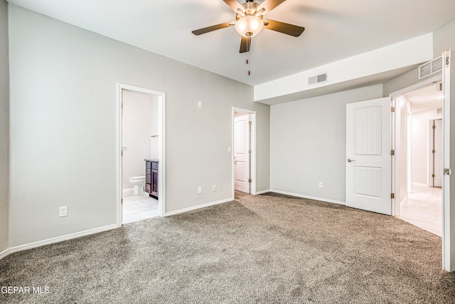 unfurnished bedroom with connected bathroom, light colored carpet, and ceiling fan