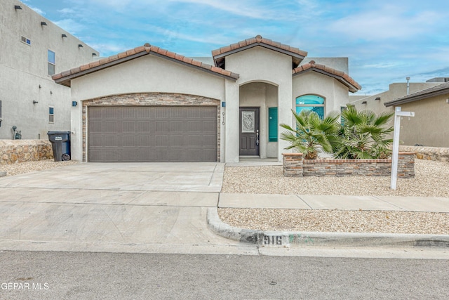 mediterranean / spanish-style house with a garage