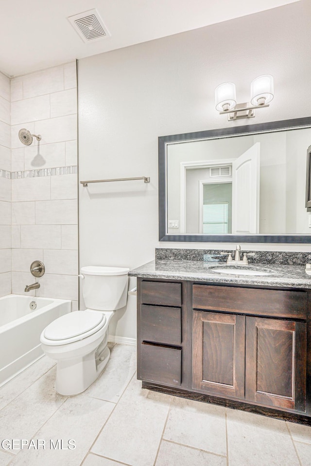 full bathroom with tile patterned flooring, vanity, toilet, and tiled shower / bath