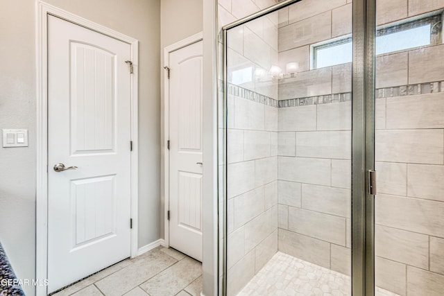 bathroom featuring tile patterned flooring and an enclosed shower