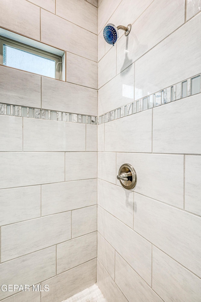 bathroom with tiled shower