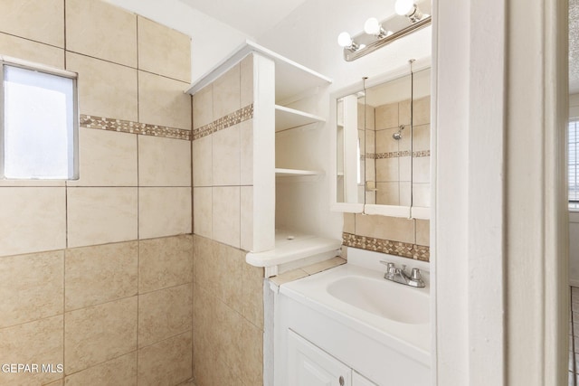 bathroom with vanity and tiled shower