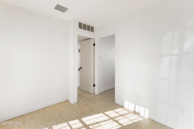 empty room with light tile patterned floors